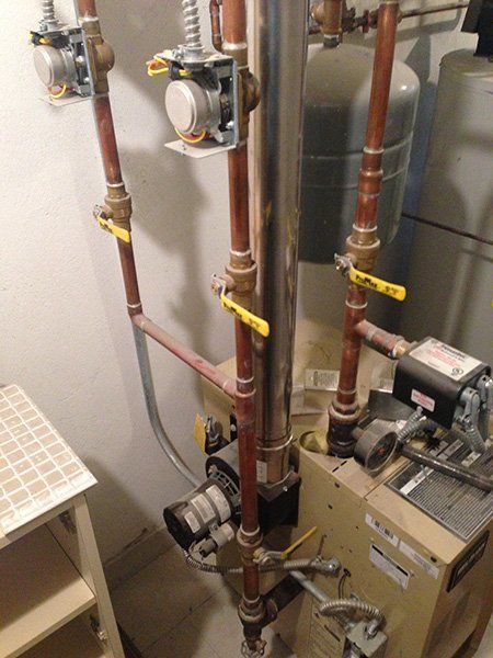 A Boiler with a Lot of Pipes and Valves on it - Passaic, NJ - Motion Plumbing & Heating LLC