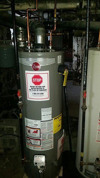 A Water Heater with a Stop Sign on it - Passaic, NJ - Motion Plumbing & Heating LLC