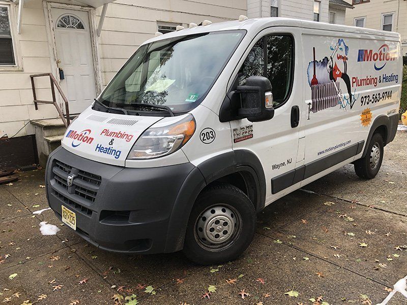 A White Van that says Motion Plumbing and Heating - Passaic, NJ - Motion Plumbing & Heating LLC